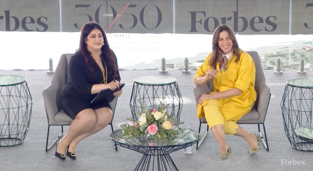 Screenshot from the ForbesWomen video series. Jenny Just, Cofounder & Managing Partner, PEAK6 is shown on stage discussing her insights on the next era of financial disruption and how she is empowering the next generation of women leaders with Maneet Ahuja, Senior Editor, Forbes.