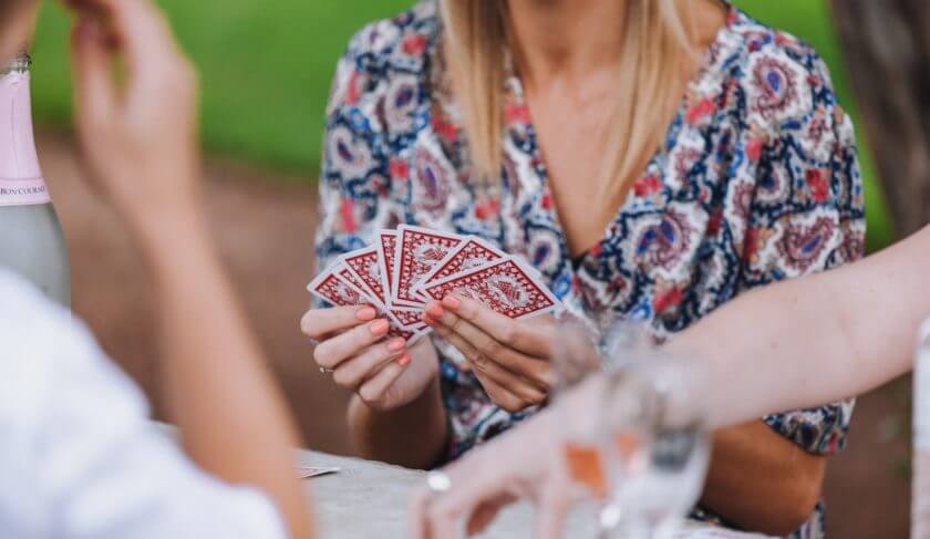 A person holding six red cards